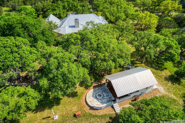 birds eye view of property with a forest view