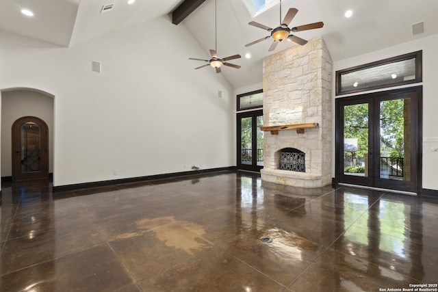 unfurnished living room with french doors, a ceiling fan, plenty of natural light, and visible vents