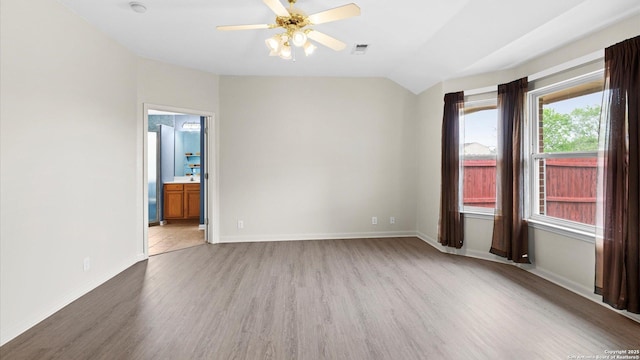 unfurnished room with light wood-style floors, baseboards, a ceiling fan, and visible vents