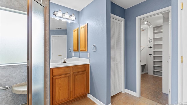 full bath with tile patterned flooring and vanity