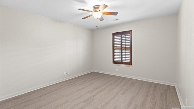 unfurnished room with baseboards, ceiling fan, visible vents, and wood finished floors