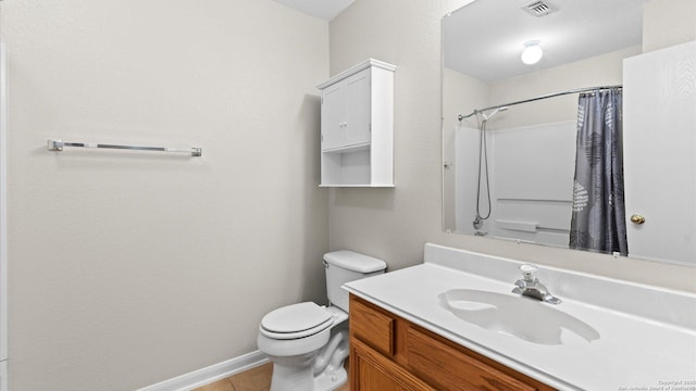 bathroom with vanity, toilet, tile patterned floors, baseboards, and visible vents