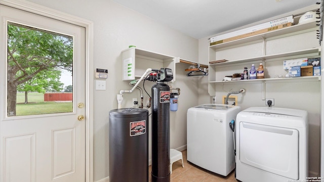 laundry area featuring light tile patterned floors, laundry area, and independent washer and dryer