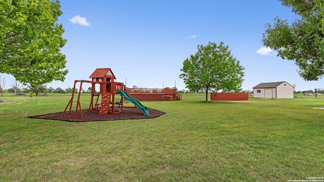 view of playground with a lawn