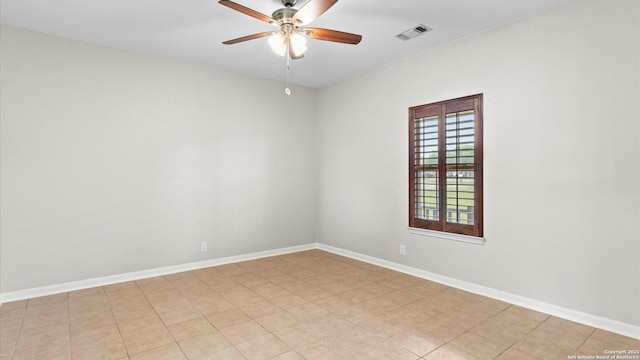 unfurnished room with baseboards, ceiling fan, and visible vents