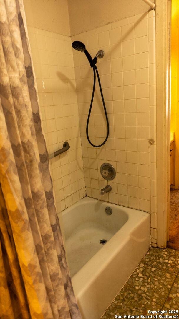 bathroom with shower / bathtub combination with curtain