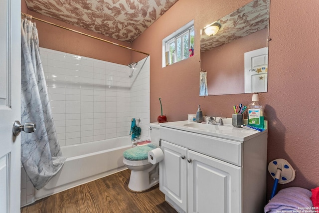 bathroom with shower / bath combo, wood finished floors, vanity, toilet, and a textured wall