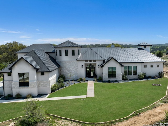 modern inspired farmhouse with a standing seam roof, stucco siding, and stone siding