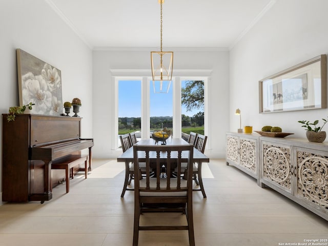 dining space with crown molding and light wood finished floors
