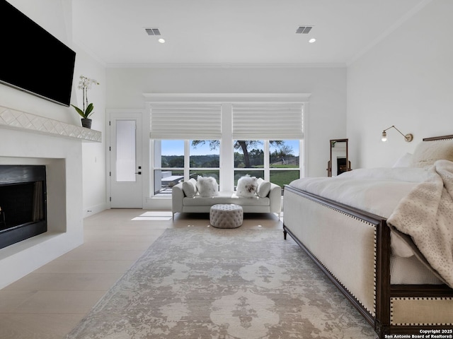 bedroom featuring ornamental molding, multiple windows, and visible vents