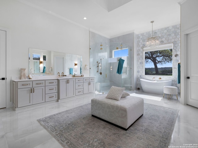 bathroom featuring vanity, a chandelier, a freestanding tub, ornamental molding, and a stall shower