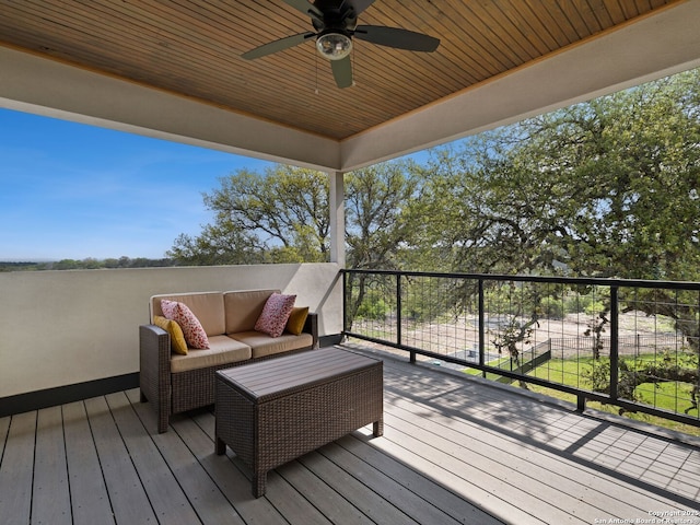 deck featuring a ceiling fan and an outdoor living space