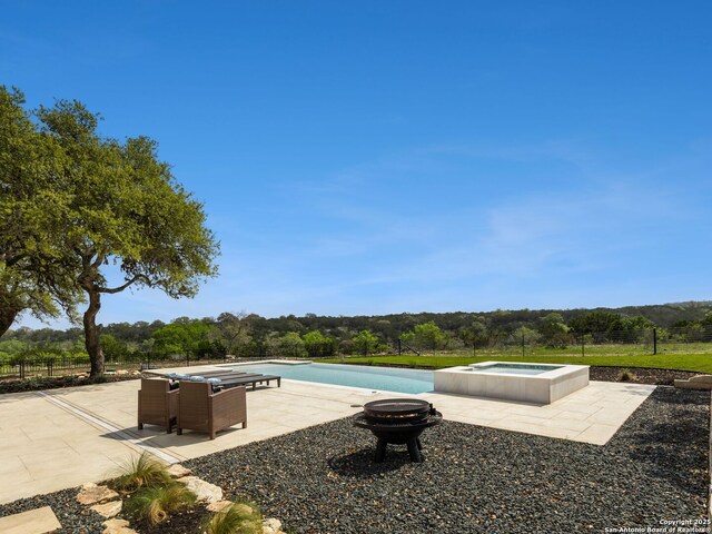 outdoor pool featuring fence, a patio, an in ground hot tub, and an outdoor fire pit