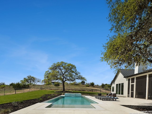 outdoor pool with a yard, a patio, fence, and a sunroom