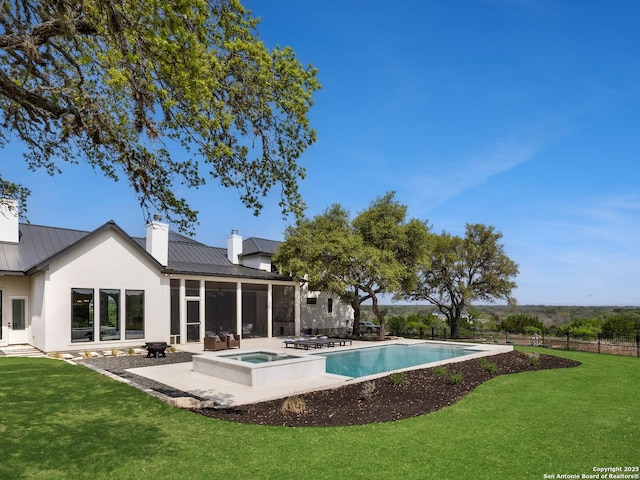 view of pool with fence, a fenced in pool, an in ground hot tub, a patio, and a yard