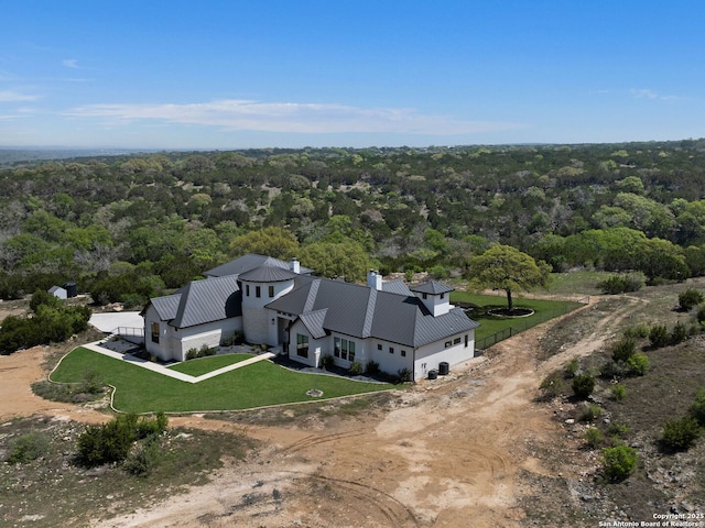 birds eye view of property featuring a view of trees