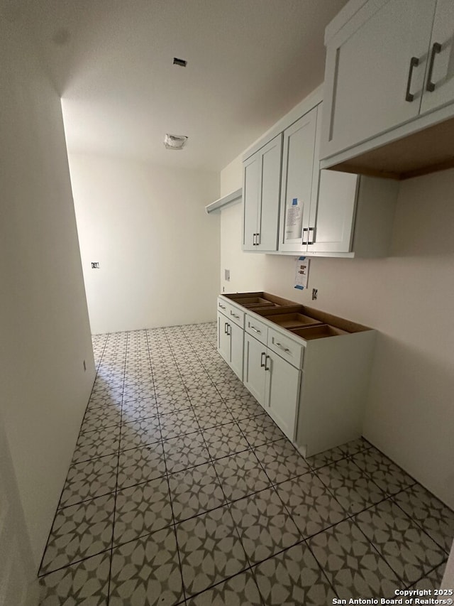 434 Hanging Oak, Spring Branch, TX 78070 - kitchen with tile patterned floors and white cabinets
