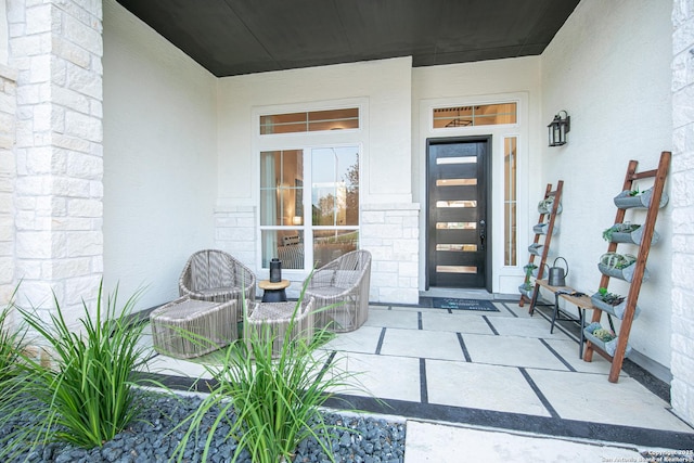 view of exterior entry with stucco siding