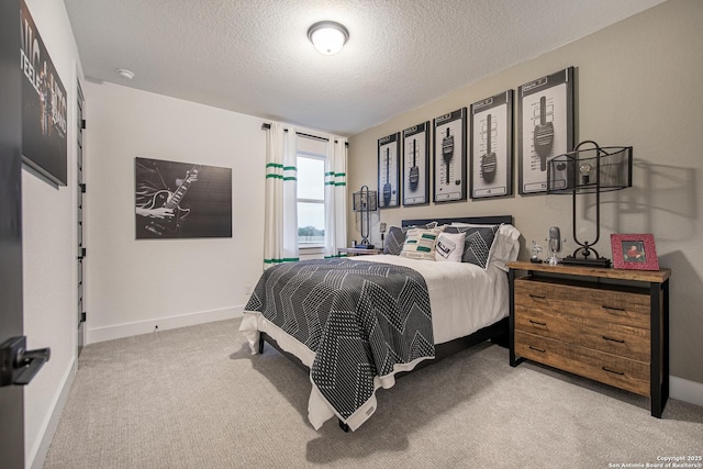 bedroom featuring a textured ceiling, light carpet, and baseboards