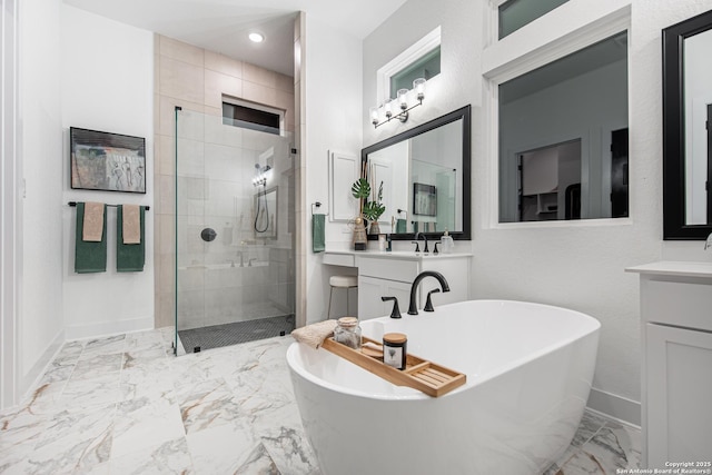 bathroom with a freestanding bath, a stall shower, baseboards, vanity, and marble finish floor