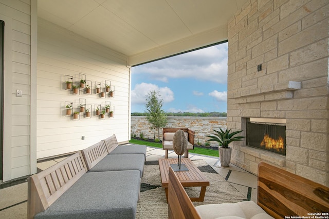 view of patio with an outdoor living space with a fireplace