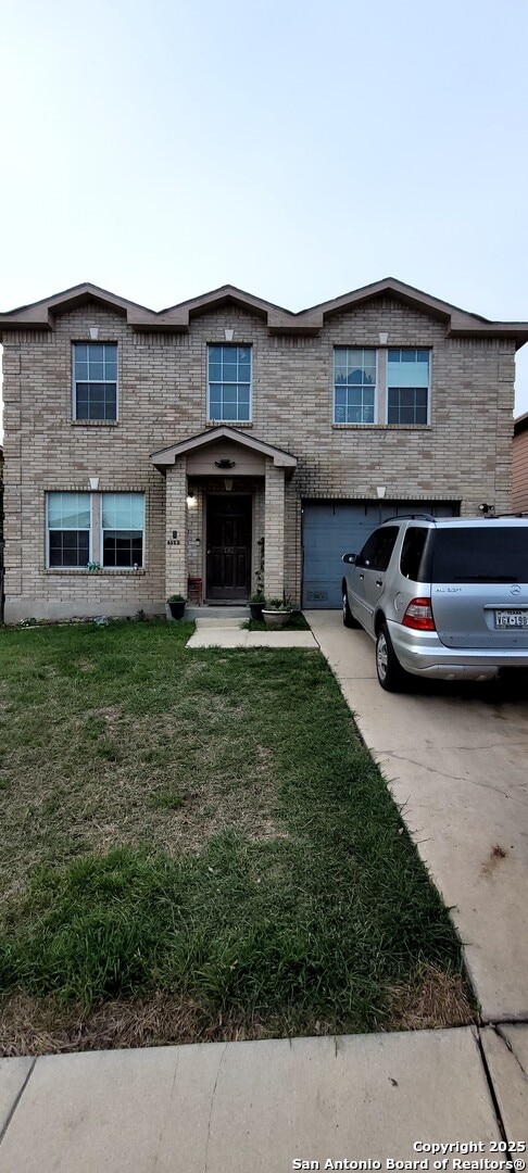 San Antonio, TX 78244 - view of front facade with concrete driveway, brick siding, an attached garage, and a front lawn