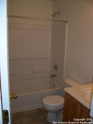 San Antonio, TX 78244 - bathroom featuring vanity, shower / tub combination, and toilet