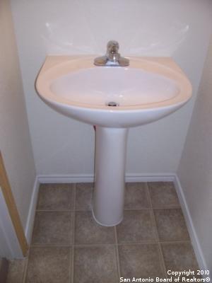 San Antonio, TX 78244 - bathroom with baseboards, a sink, and tile patterned floors