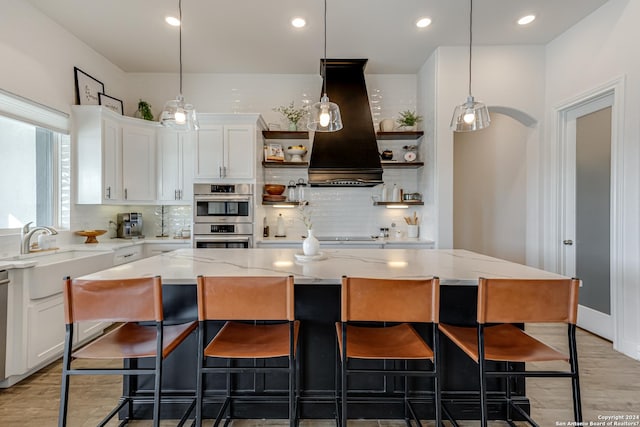 kitchen featuring open shelves, appliances with stainless steel finishes, a sink, premium range hood, and tasteful backsplash