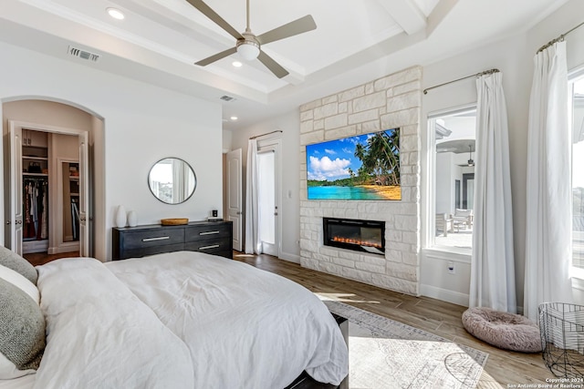 bedroom featuring visible vents, recessed lighting, wood finished floors, and a fireplace
