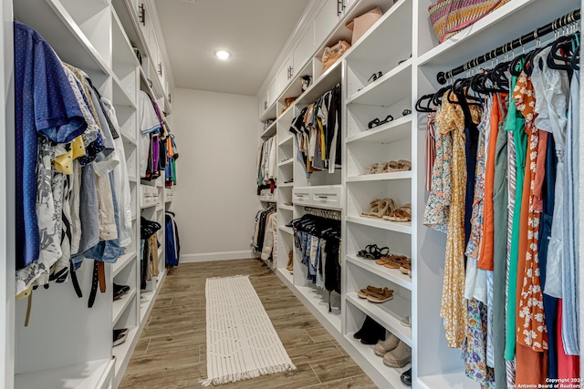 walk in closet featuring light wood finished floors