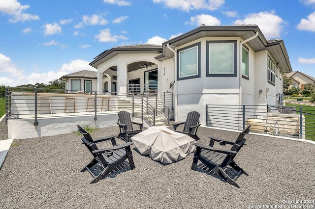 rear view of property with fence and stucco siding