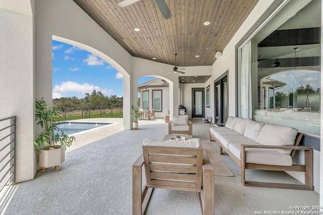 view of patio with fence, outdoor lounge area, a ceiling fan, and a fenced in pool