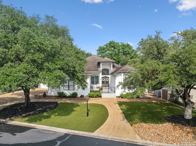 view of front of property with a tiled roof and stucco siding