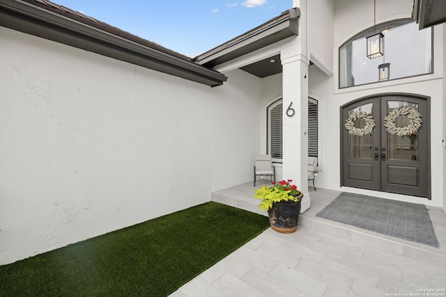 property entrance with french doors and stucco siding