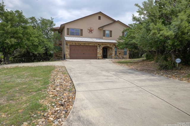 view of front of house with a garage, stone siding, and concrete driveway