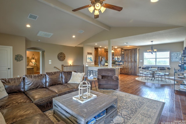 living room with wood-type flooring, arched walkways, visible vents, and ceiling fan with notable chandelier