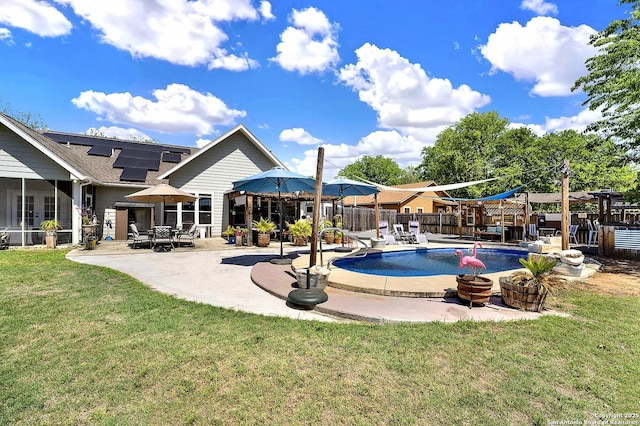 view of swimming pool with fence, a sunroom, a fenced in pool, a patio area, and a yard