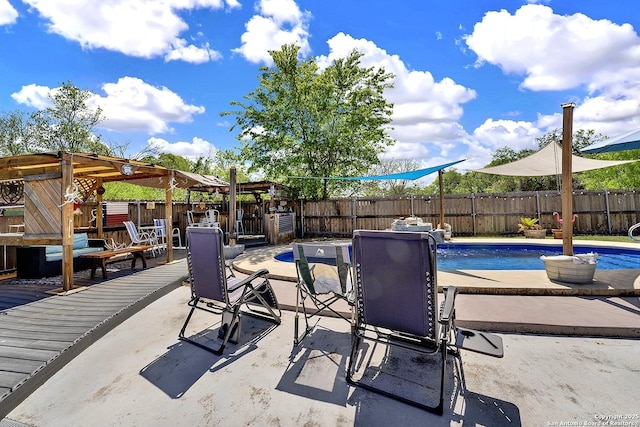 view of patio with a fenced in pool, a wooden deck, and a fenced backyard