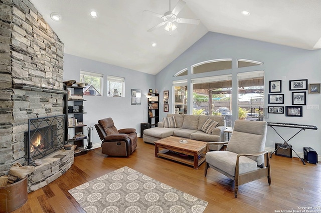 living area with a fireplace, high vaulted ceiling, a ceiling fan, recessed lighting, and wood finished floors