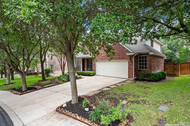 18607 Double Frk, San Antonio, TX 78258 - view of front of house featuring concrete driveway, brick siding, a front yard, and a garage