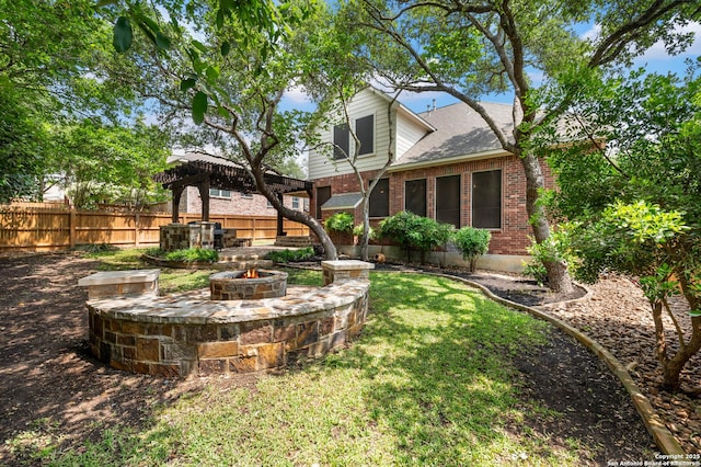 18607 Double Frk, San Antonio, TX 78258 - back of house with fence, a gazebo, an outdoor fire pit, brick siding, and a yard