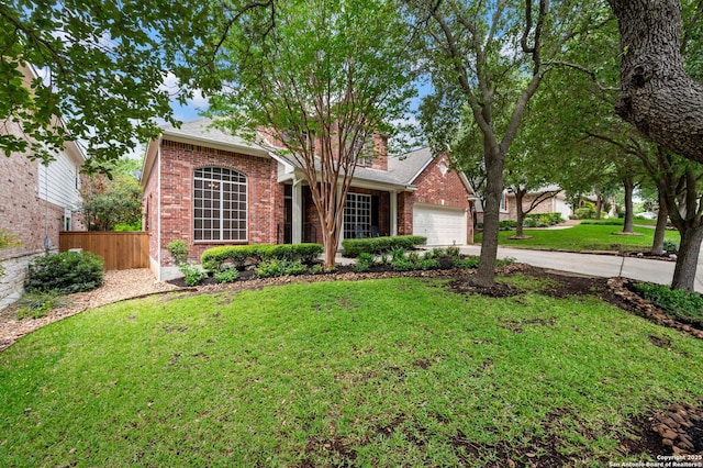 18607 Double Frk, San Antonio, TX 78258 - view of front of property with a front lawn, fence, brick siding, concrete driveway, and an attached garage