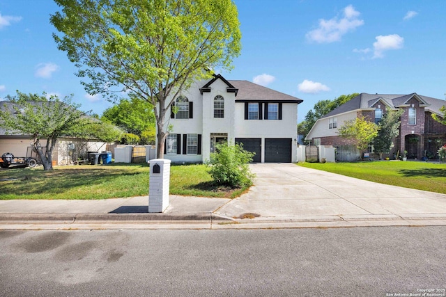 traditional-style home featuring an attached garage, a front lawn, fence, and concrete driveway