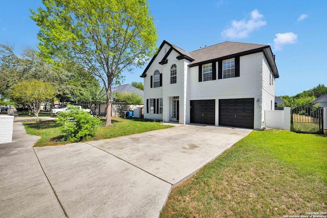 view of front of property with an attached garage, a front lawn, fence, and driveway