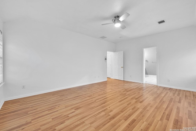unfurnished bedroom featuring light wood-style flooring, a ceiling fan, baseboards, ensuite bathroom, and visible vents