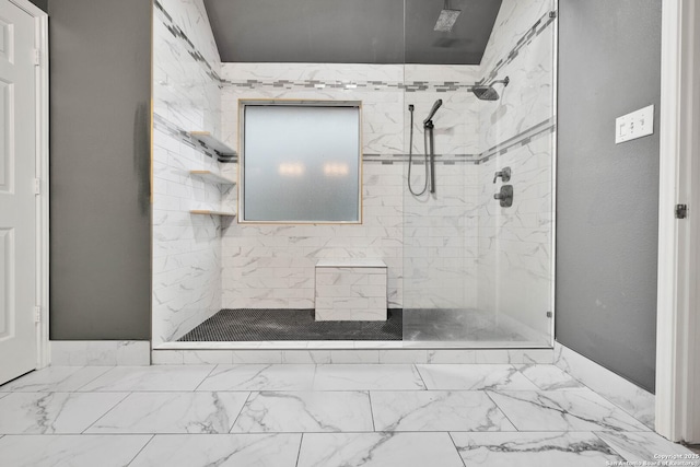 full bath featuring tiled shower and marble finish floor