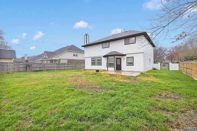 back of house featuring a fenced backyard, a patio, a chimney, and a lawn