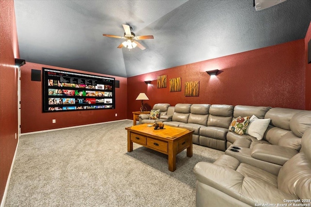 home theater room featuring a ceiling fan, carpet, and vaulted ceiling