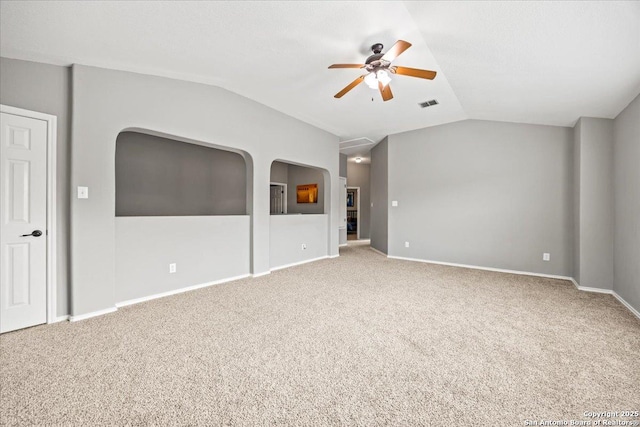 interior space with carpet floors, visible vents, lofted ceiling, baseboards, and ceiling fan